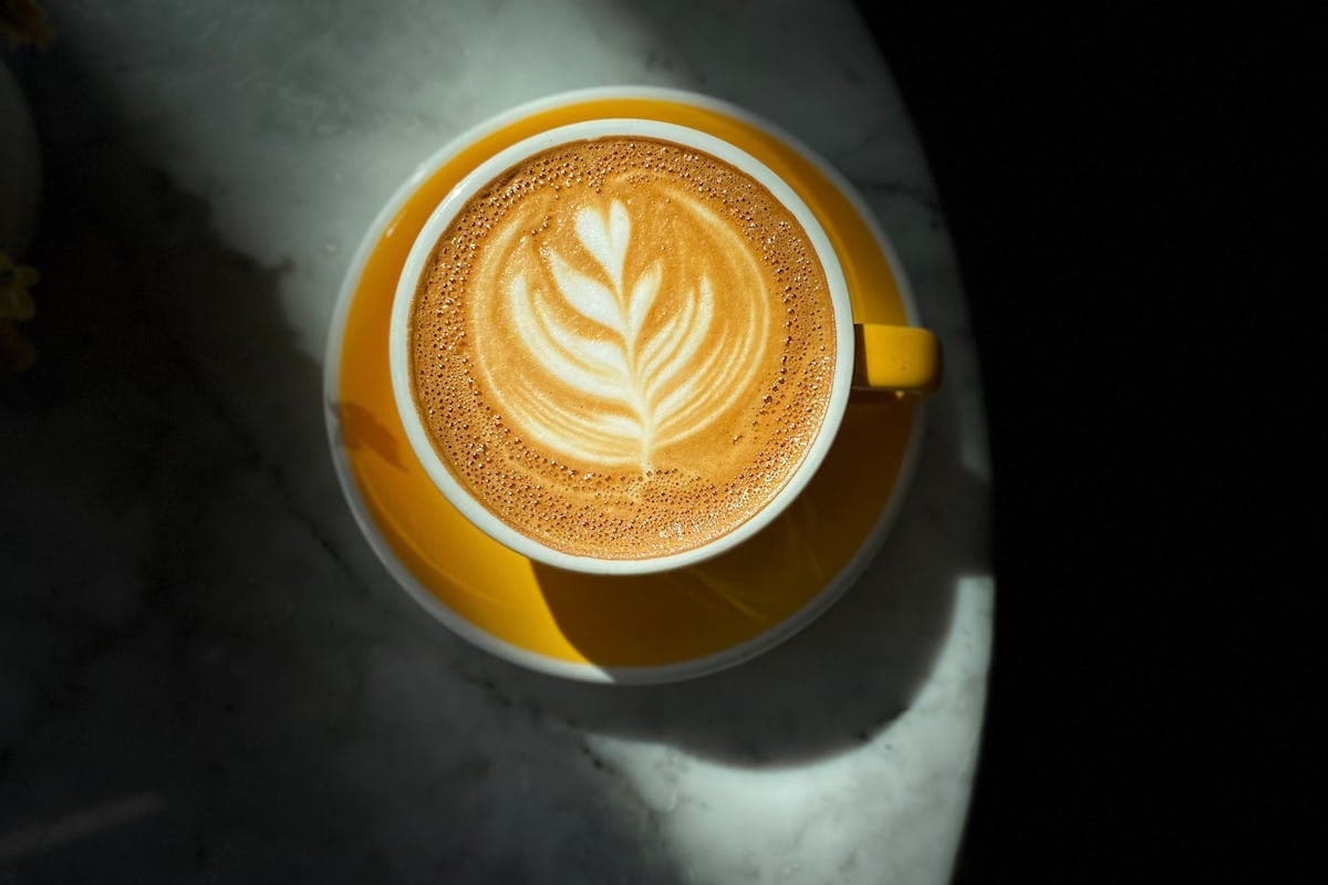 Freshly whisked classic matcha latte in a ceramic mug with microfoam.